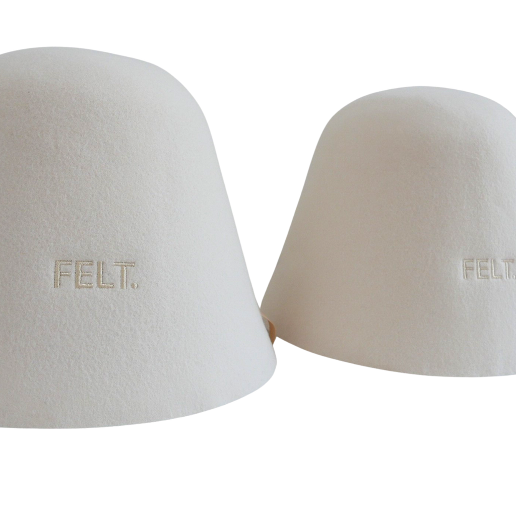 Two The Classic merino wool sauna hats in the traditional bell shape, embroidered with the FELT. logo