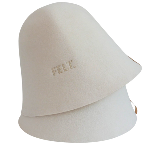 Close-up of two stacked 4mm Australian Merino wool felt The Classic sauna hats showing the embossed FELT. branding