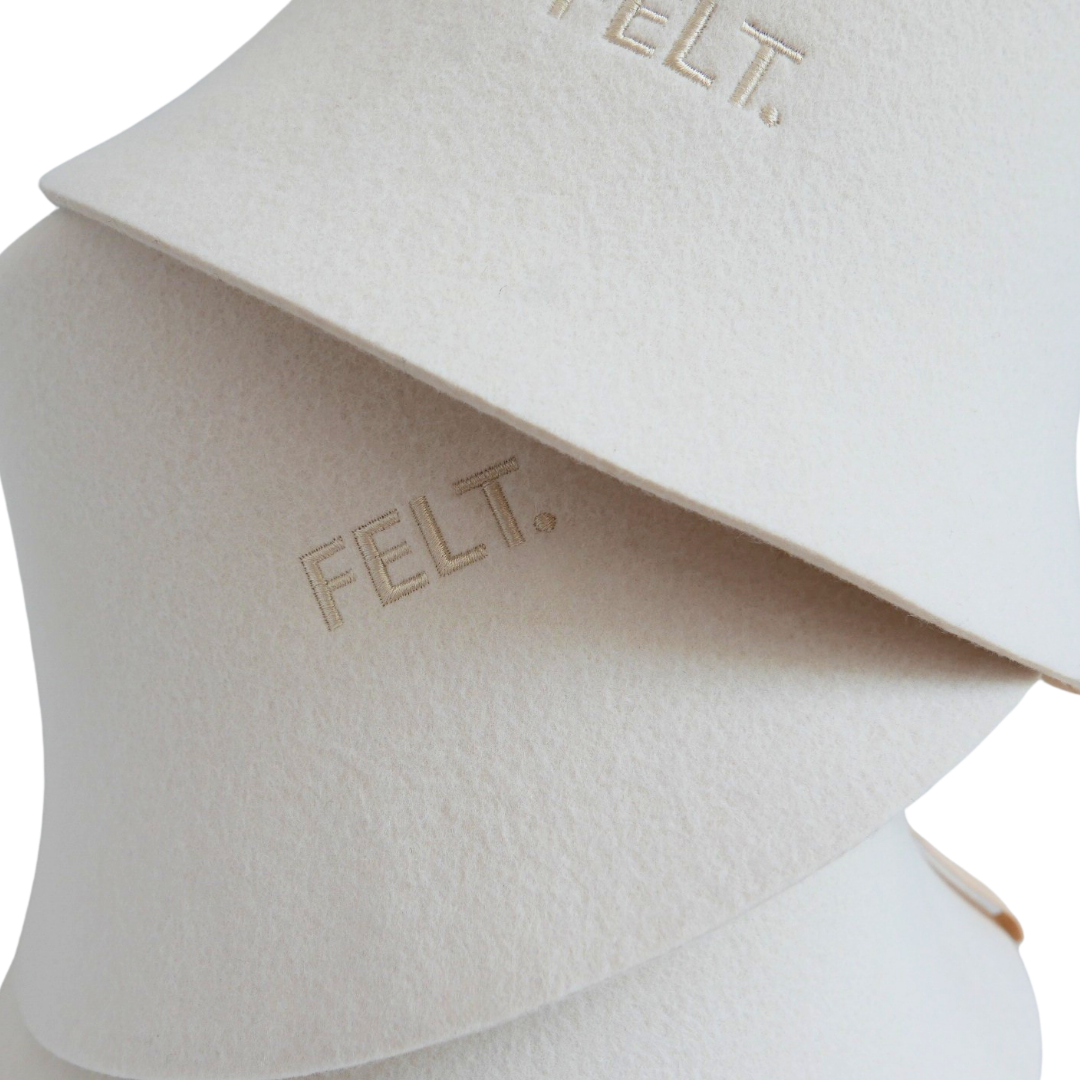 Close-up of three stacked 4mm Australian Merino wool felt The Modern sauna hats showing the embossed FELT. branding
